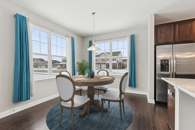 dining room featuring dark hardwood / wood-style flooring and plenty of natural light