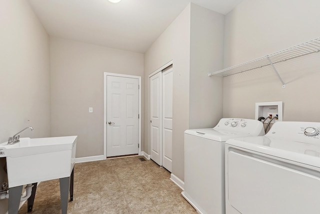 washroom featuring separate washer and dryer and sink