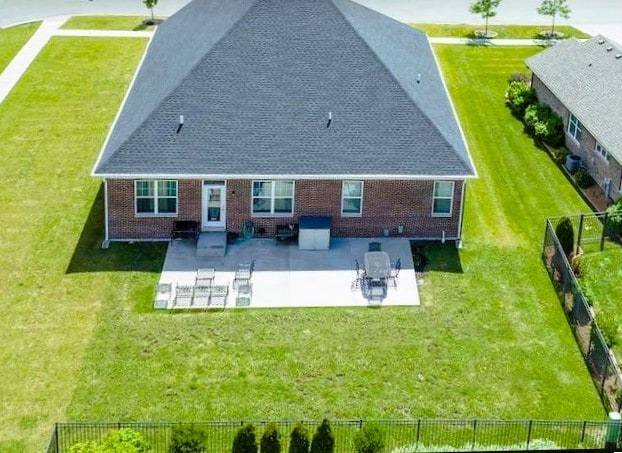 back of house featuring a patio area and a lawn