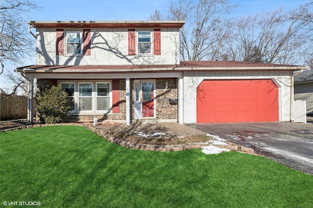 view of front of home with a front yard and a garage