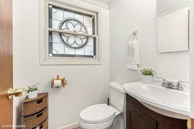 bathroom with toilet, ornamental molding, and vanity