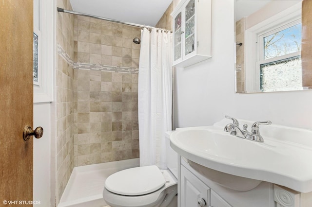 bathroom with toilet, vanity, and walk in shower