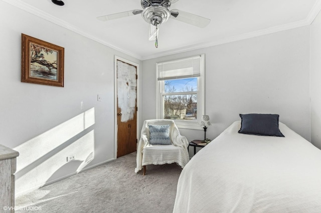 carpeted bedroom featuring ceiling fan and ornamental molding