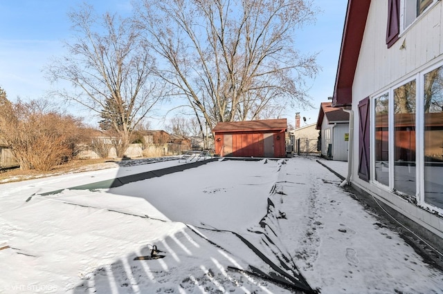 yard covered in snow with a shed