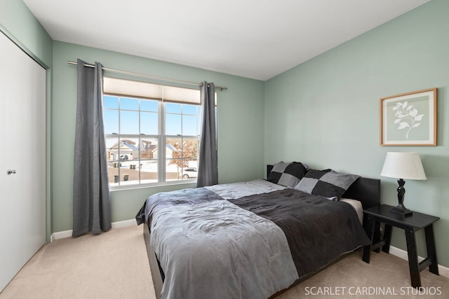 bedroom featuring a closet and light carpet