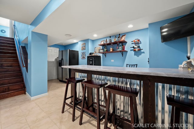 bar with stainless steel fridge with ice dispenser