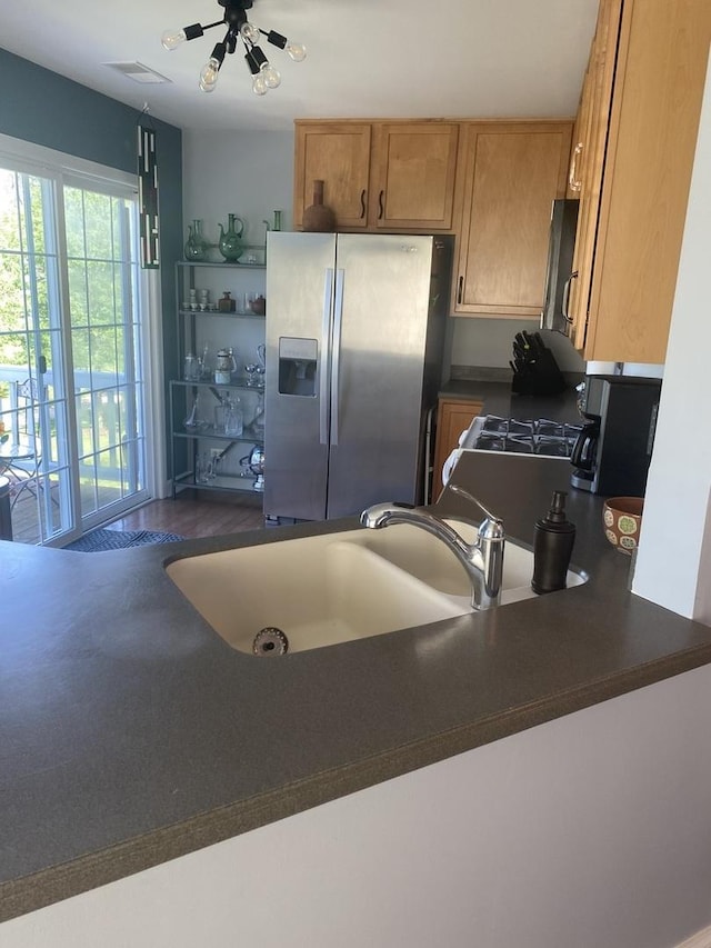 kitchen with stainless steel fridge and sink