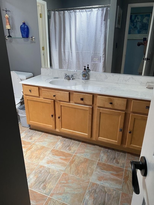 bathroom featuring toilet and vanity