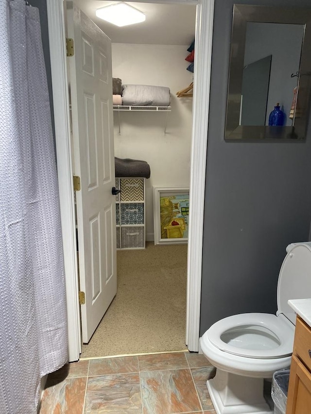 bathroom featuring toilet and vanity