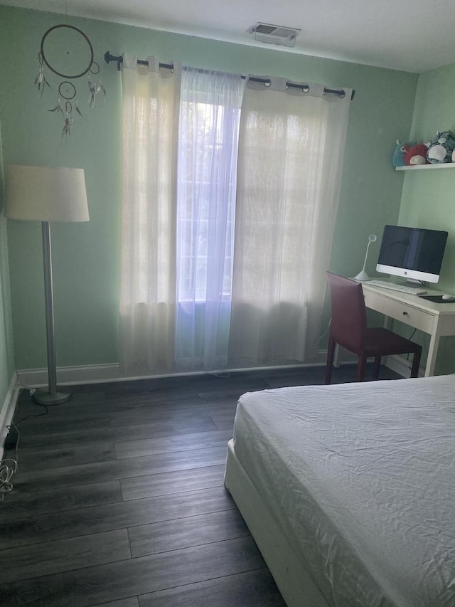 bedroom with dark wood-type flooring