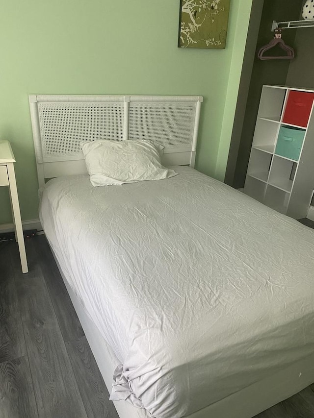 bedroom with dark hardwood / wood-style flooring