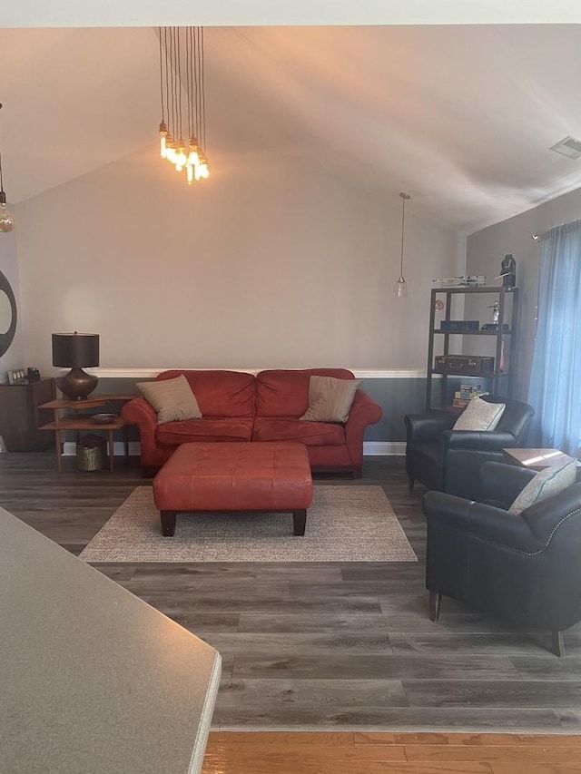 living room with vaulted ceiling and hardwood / wood-style flooring