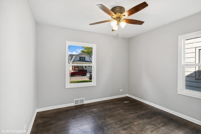 spare room featuring ceiling fan and dark hardwood / wood-style floors