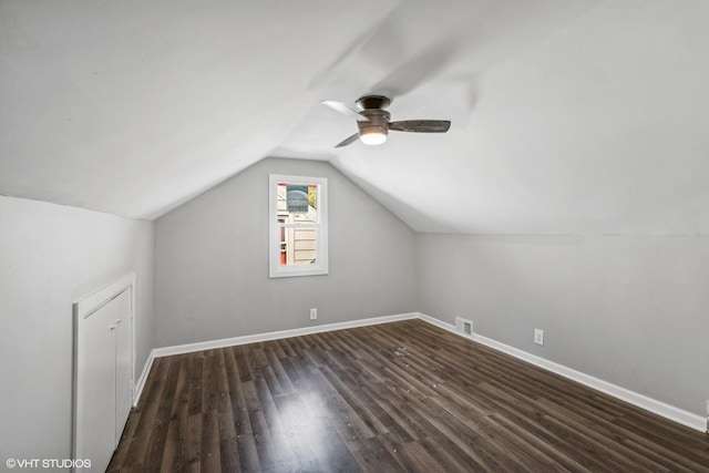 bonus room with ceiling fan, dark wood-type flooring, and vaulted ceiling