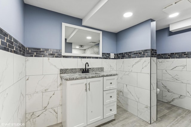 bathroom featuring tile walls and vanity