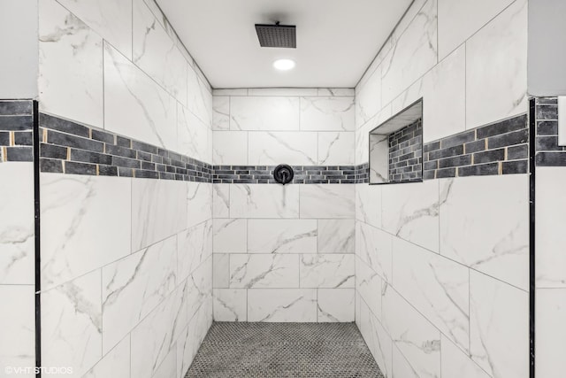 bathroom with tiled shower