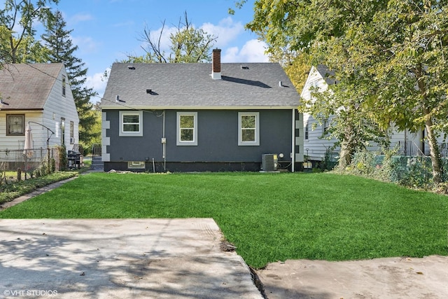 back of house with central air condition unit, a yard, and a patio area