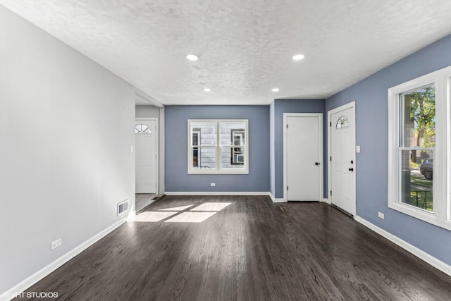 entryway featuring a textured ceiling and dark hardwood / wood-style floors