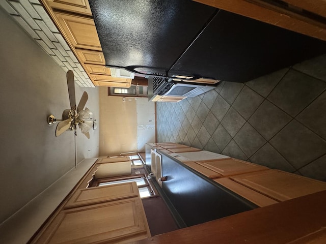 kitchen featuring light brown cabinetry, ceiling fan, and tile countertops