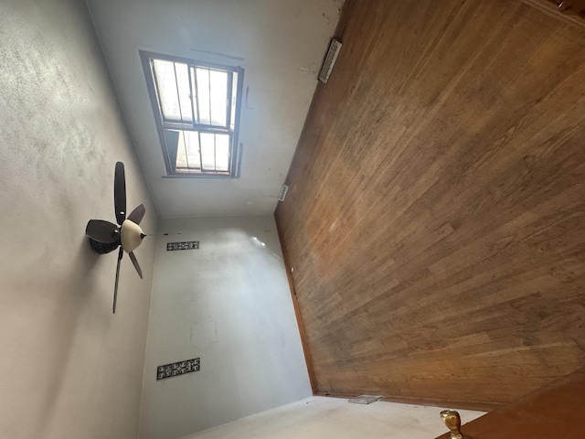 spare room featuring wooden walls