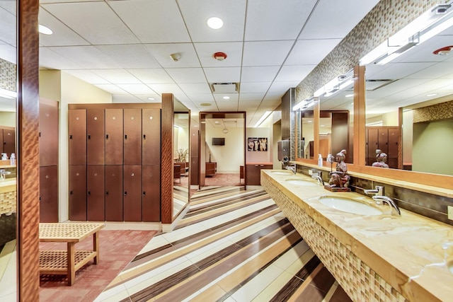 bathroom featuring a paneled ceiling, vanity, and tile patterned floors