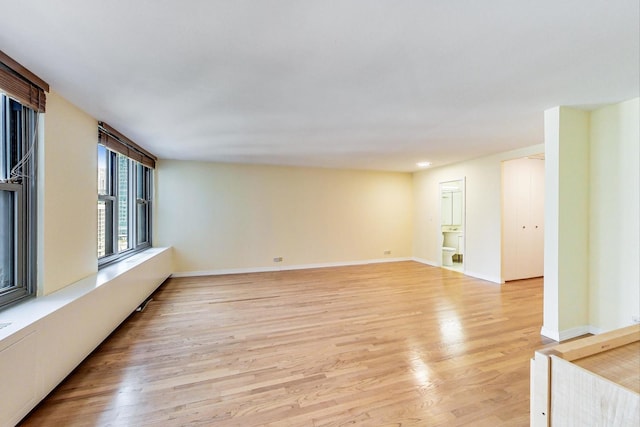 empty room with light hardwood / wood-style flooring