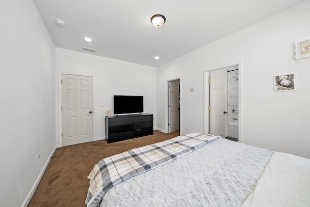 carpeted bedroom featuring ensuite bath