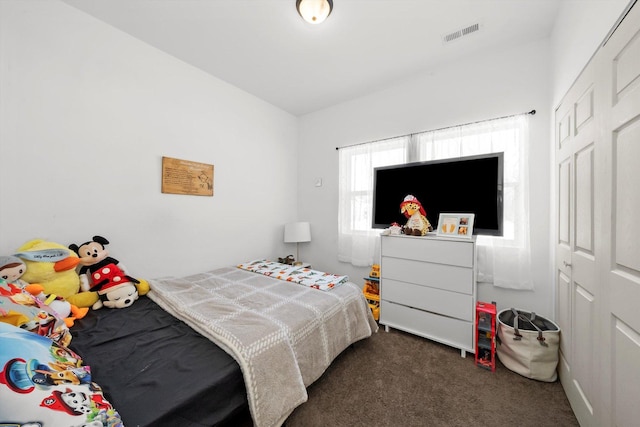 carpeted bedroom with a closet