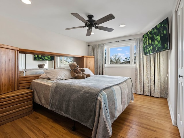 bedroom with ceiling fan and light hardwood / wood-style floors