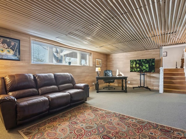 living room featuring wooden ceiling, wood walls, and carpet