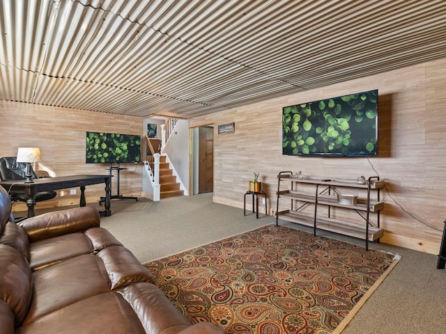 living room featuring wood walls and carpet