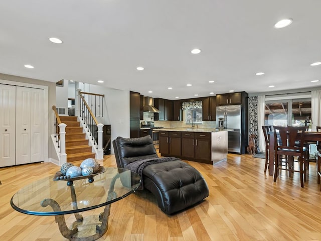 living room featuring light hardwood / wood-style floors and sink