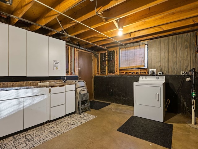 laundry room with washer / clothes dryer, wood walls, and cabinets