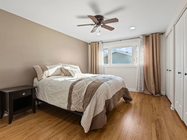 bedroom featuring light wood-type flooring, ceiling fan, and a closet