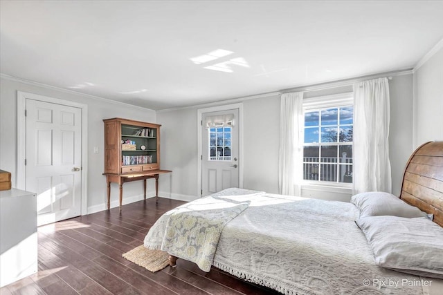 bedroom with ornamental molding, dark wood-style flooring, and baseboards