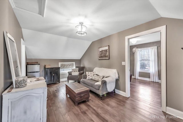 living room with lofted ceiling, hardwood / wood-style flooring, and baseboards