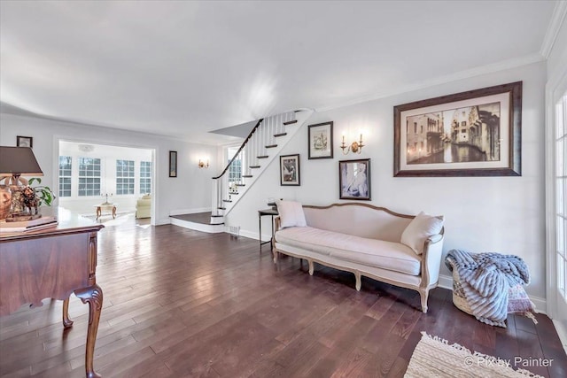 living area with baseboards, stairway, dark wood-type flooring, and ornamental molding