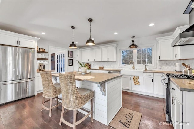 kitchen featuring dark wood-style floors, open shelves, appliances with stainless steel finishes, and white cabinets