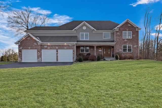 view of front of home with a front yard and a garage