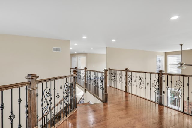 corridor with hardwood / wood-style floors