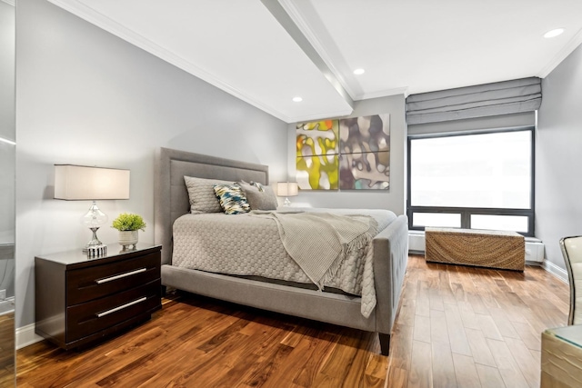 bedroom featuring crown molding and dark hardwood / wood-style floors