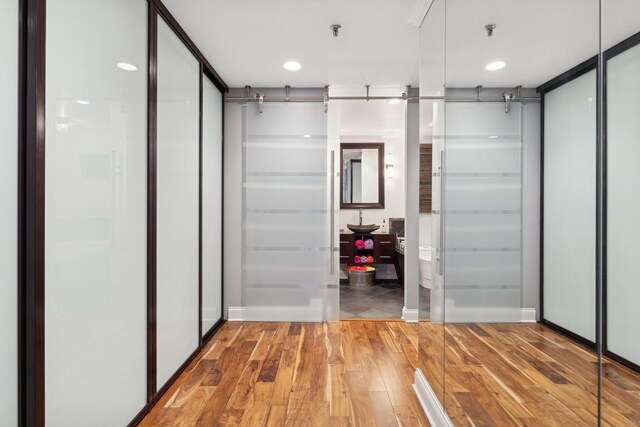 corridor with hardwood / wood-style floors