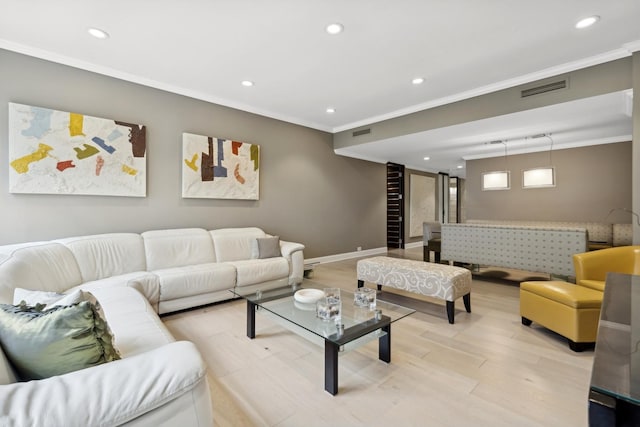 living room featuring ornamental molding and light wood-type flooring