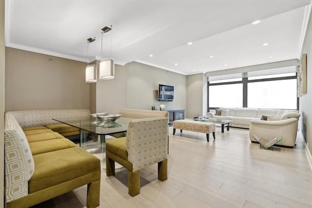 dining space with crown molding and light hardwood / wood-style floors