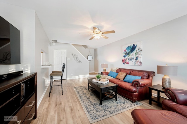 living room featuring ceiling fan and light hardwood / wood-style floors