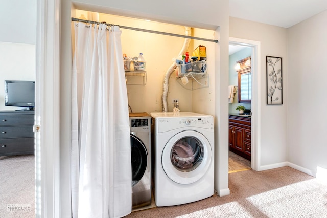 washroom featuring washing machine and dryer and light carpet