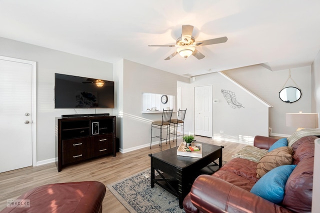 living room with ceiling fan and light hardwood / wood-style flooring