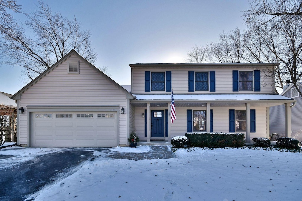 front of property with covered porch and a garage