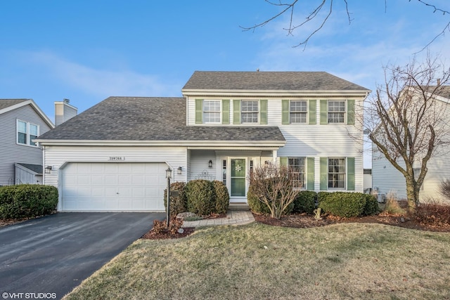 view of front of home featuring a garage and a front lawn