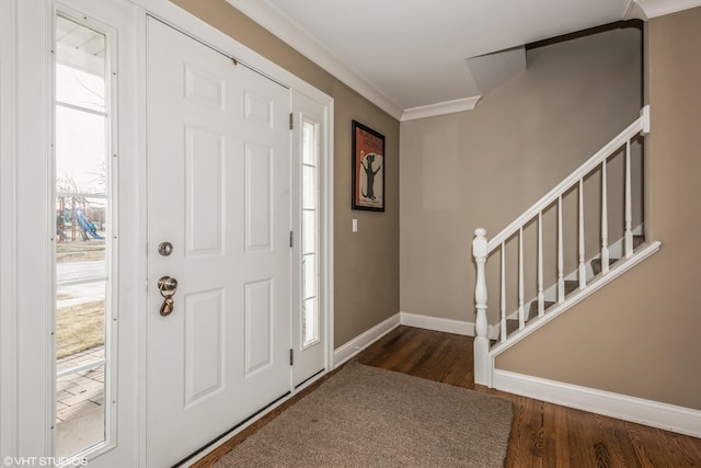 entrance foyer featuring dark wood-type flooring and ornamental molding